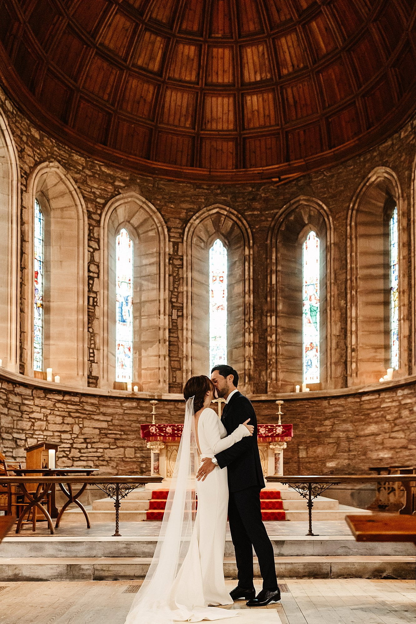 bride and groom wedding ceremony drumtochty castle inside St Palladius church first kiss