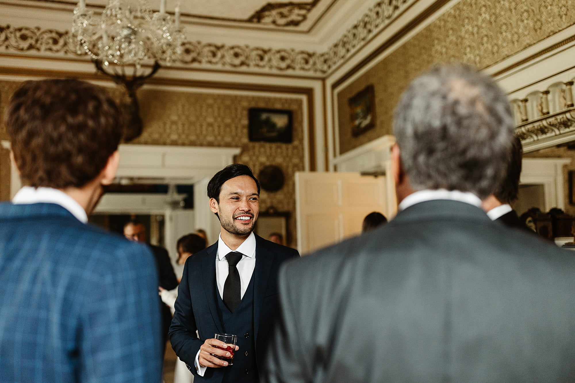 drumtochty castle drinks reception inside gold room groom Indochino suit