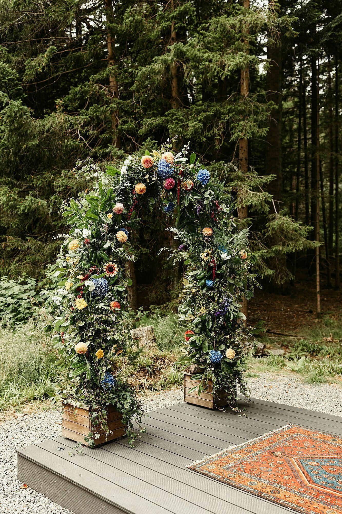 glen dye outdoor ceremony setup flower arch hays flowers colourful