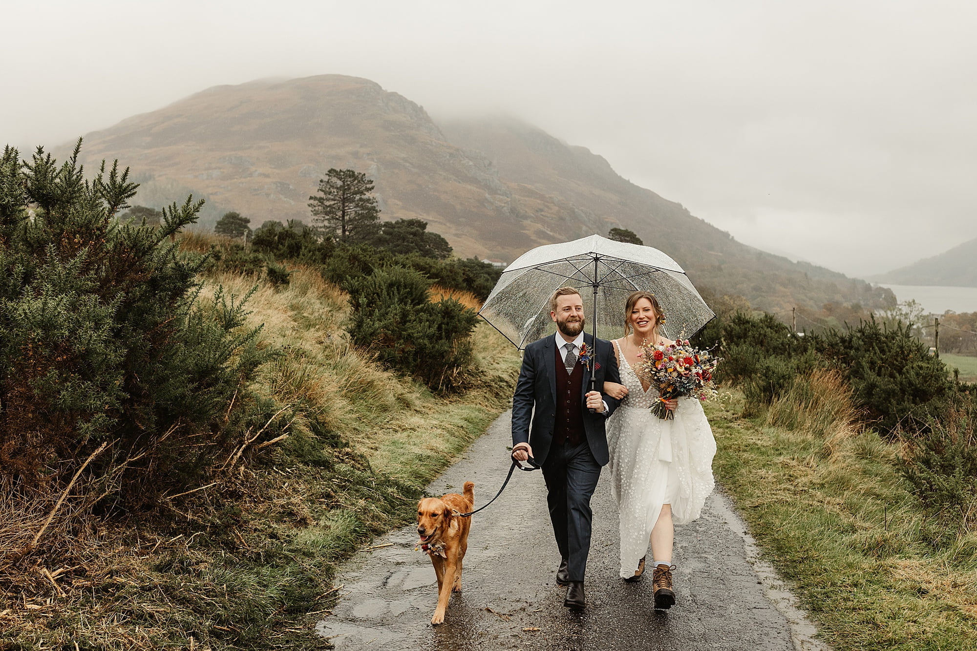 monachyle mhor elopement outside raining umbrella walk to ceremony hiking boots bride