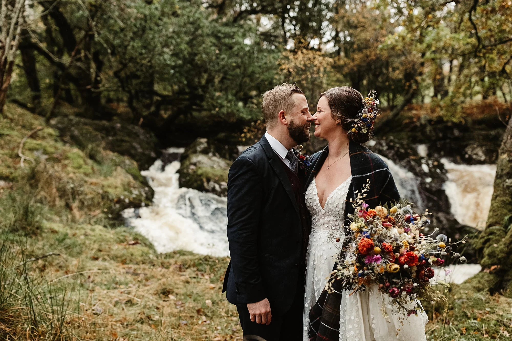 couple portraits photos bride and groom monachyle mhor Layla Robinson Design dried flower bouquet Ivory Grace Bridal wedding dress waterfall