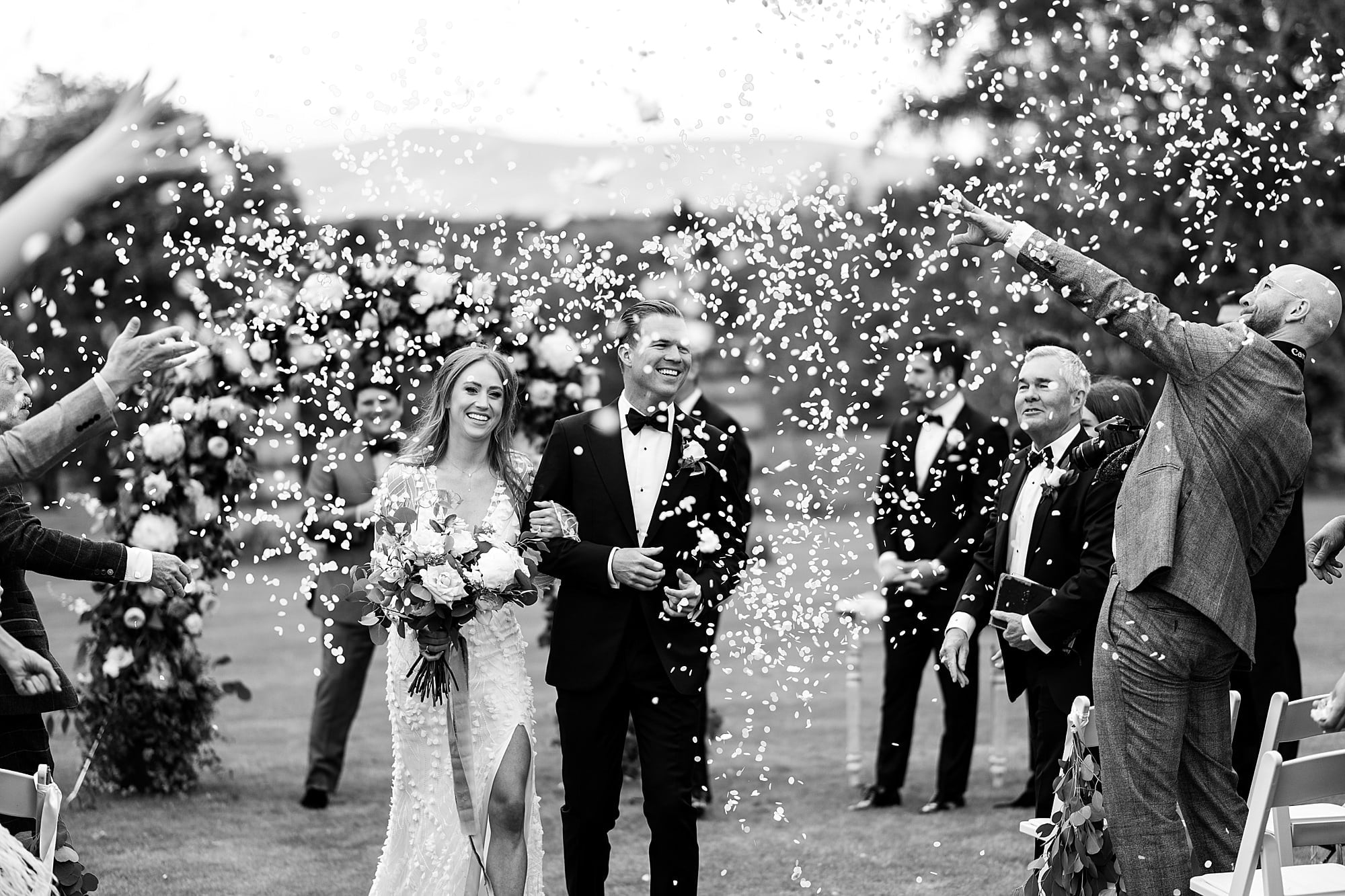 raemoir house outdoor ceremony wedding bride and groom confetti throw