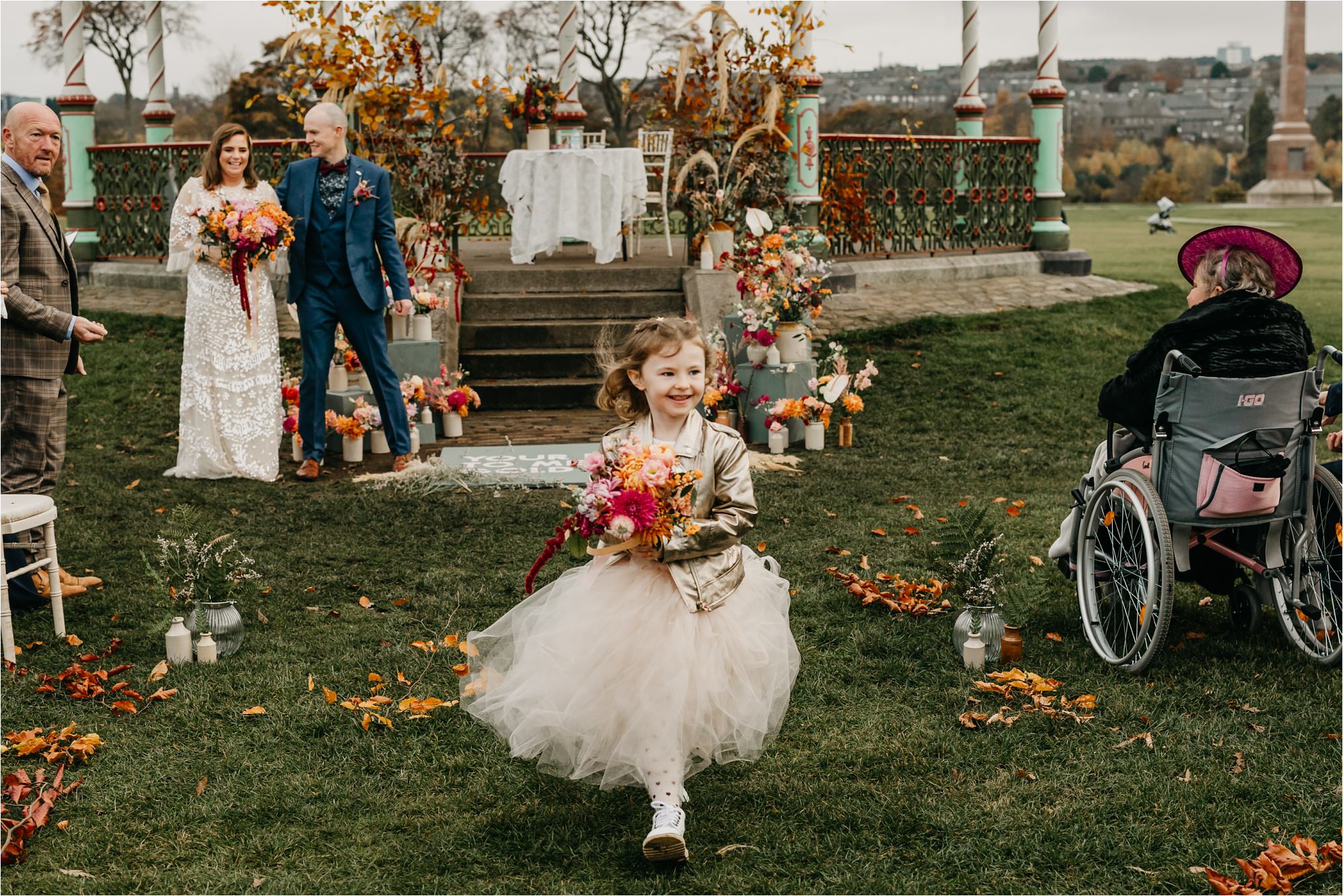 Duthie Park bandstand aberdeen micro wedding flower girl in gold leather jacket and tulle skirt walking down aisle