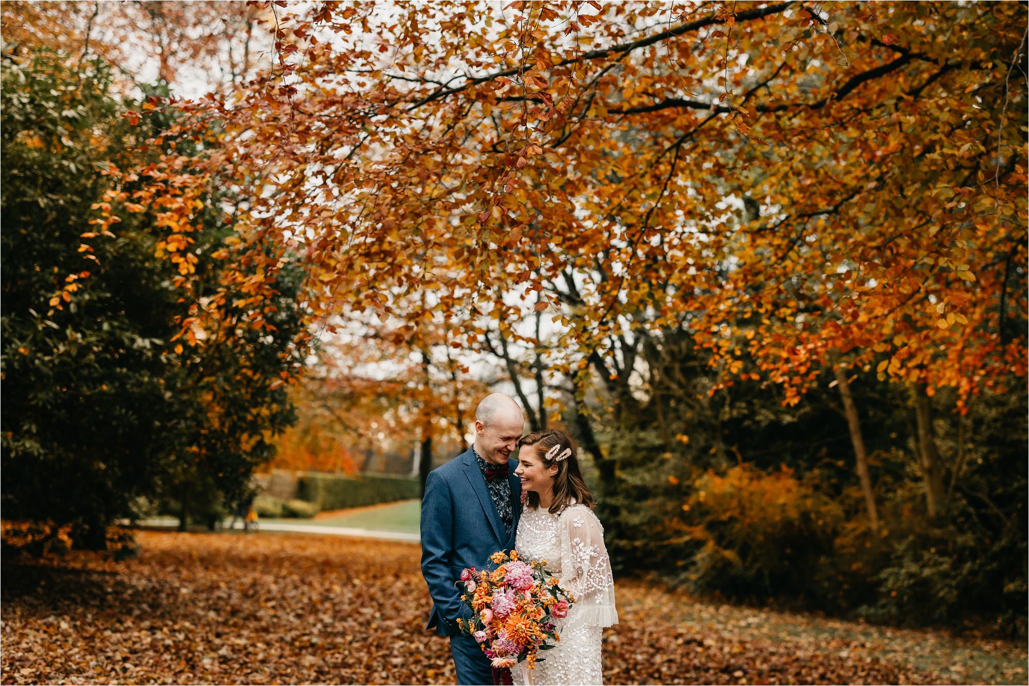 Duthie Park aberdeen micro wedding bride groom portrait in autumn winter leaves fauna folk flowers lush wild colourful bouquet needle and thread dress