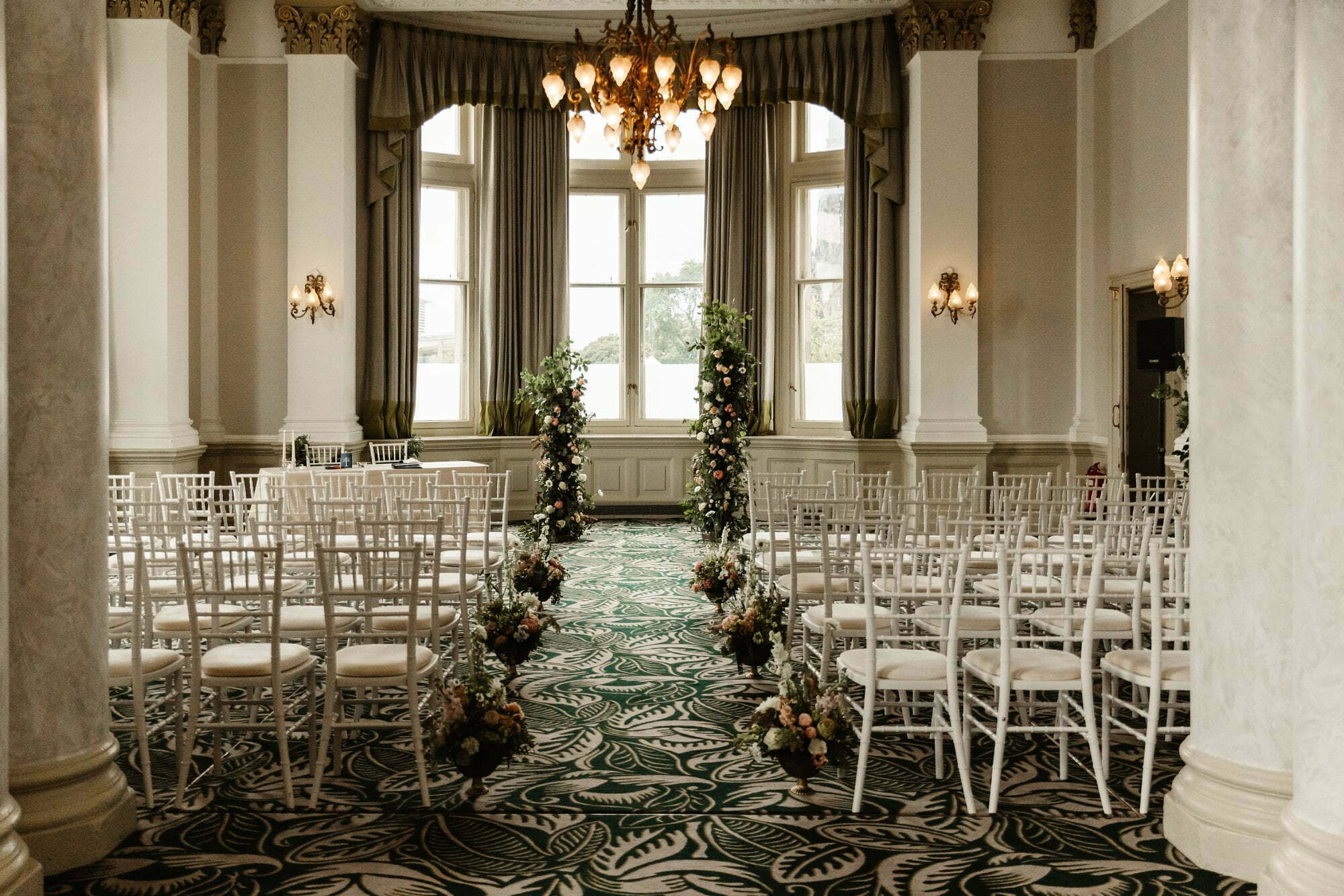 the balmoral edinburgh wedding ceremony set up inside with floral arch
