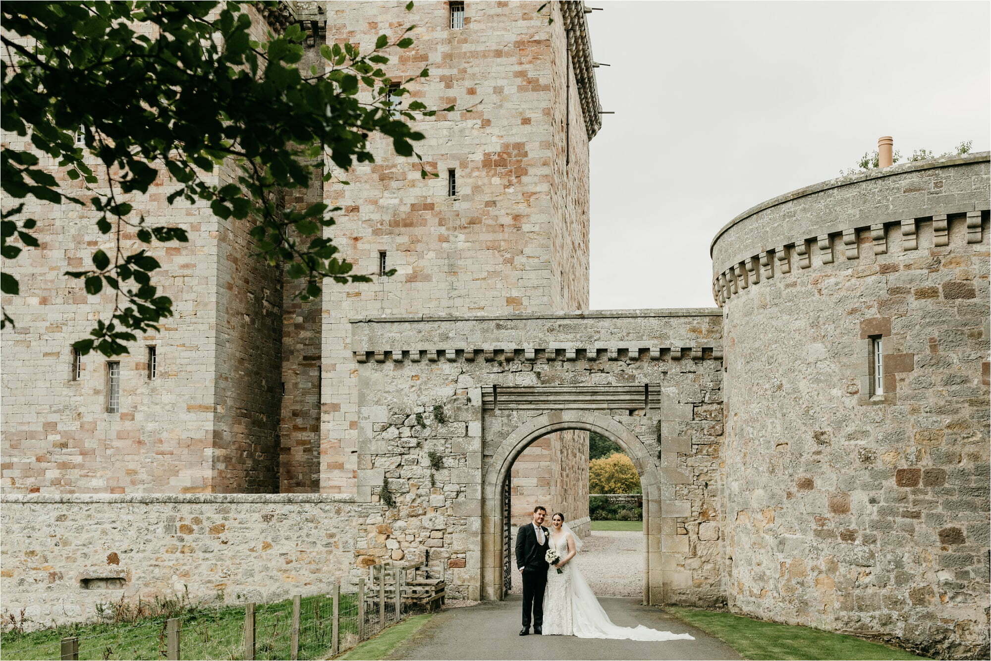 borthwick castle micro wedding bride groom portraits outside in castle grounds castle gate