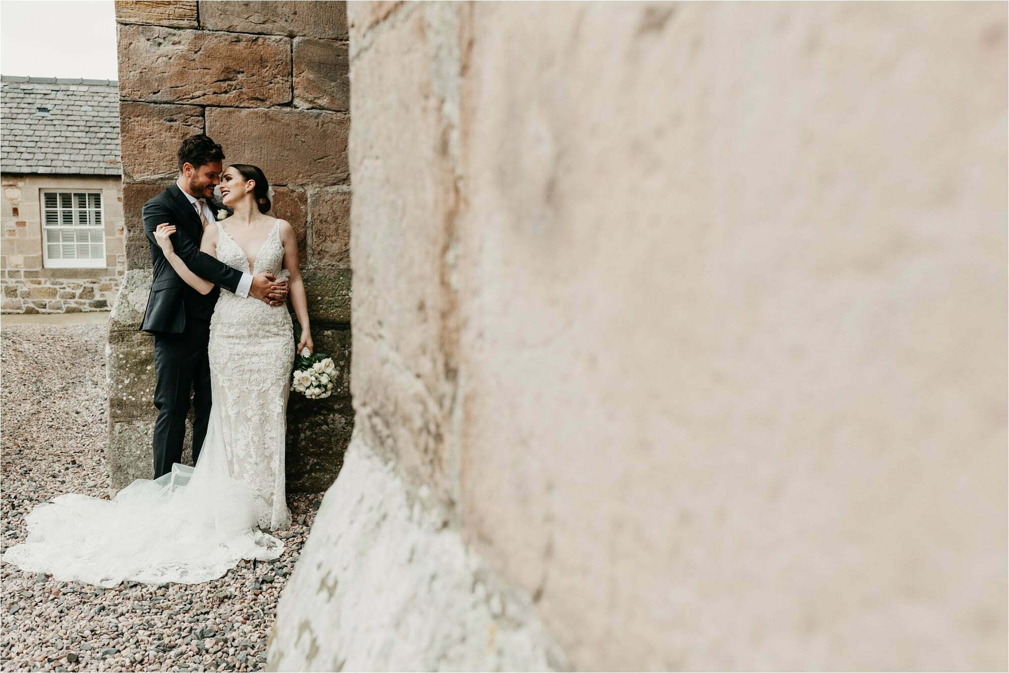 borthwick castle micro wedding bride groom portraits outside in castle grounds castle wall