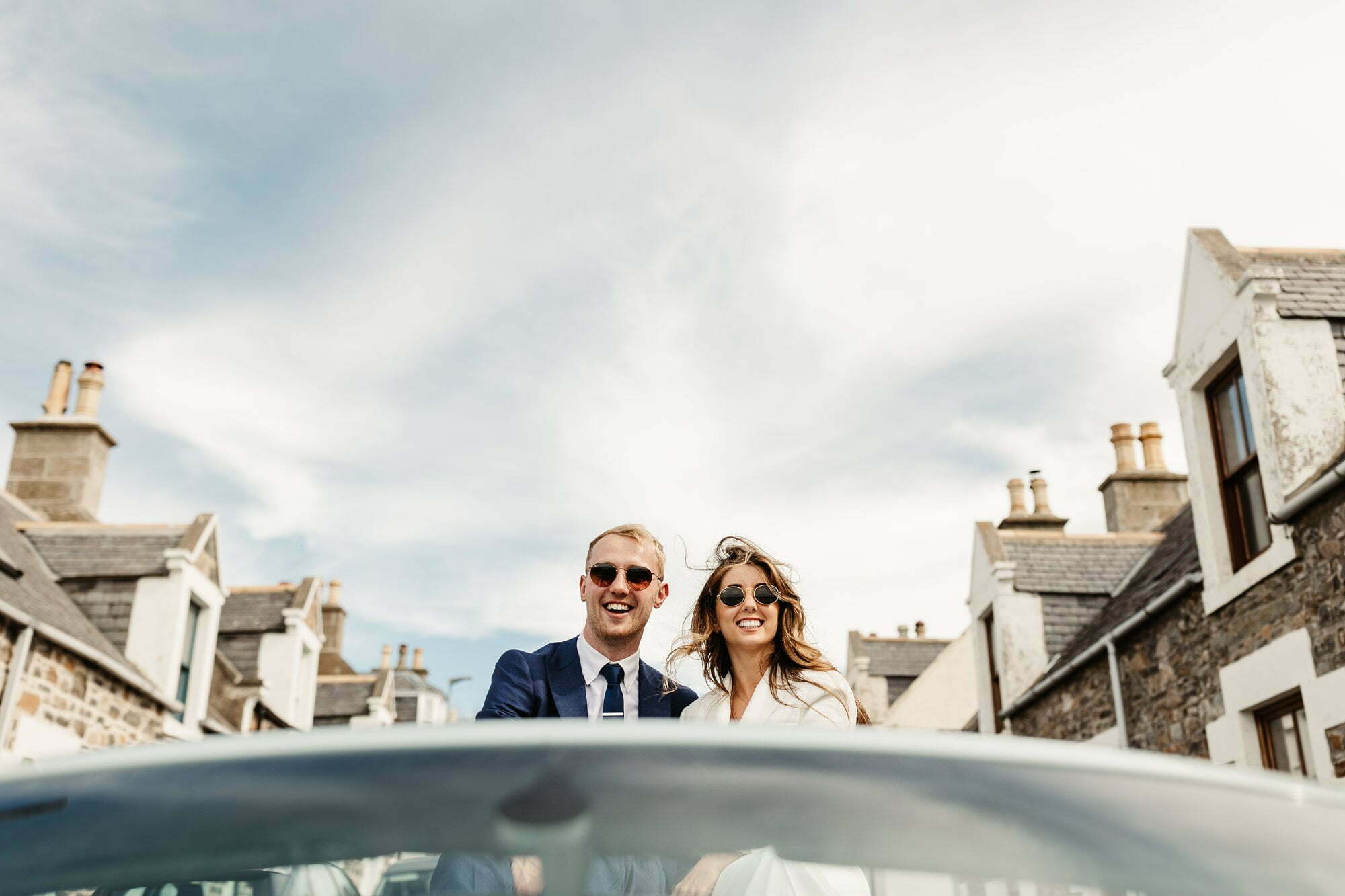 coastal micro wedding scotland luxury style bride groom suits sunglasses cullen aberdeenshire