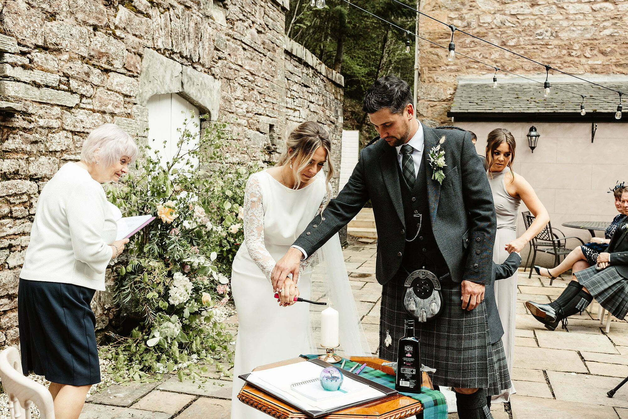 bride-groom-tartan-kilt-pronovias-atelier-lace-wedding-dress-drumtochty-castle
