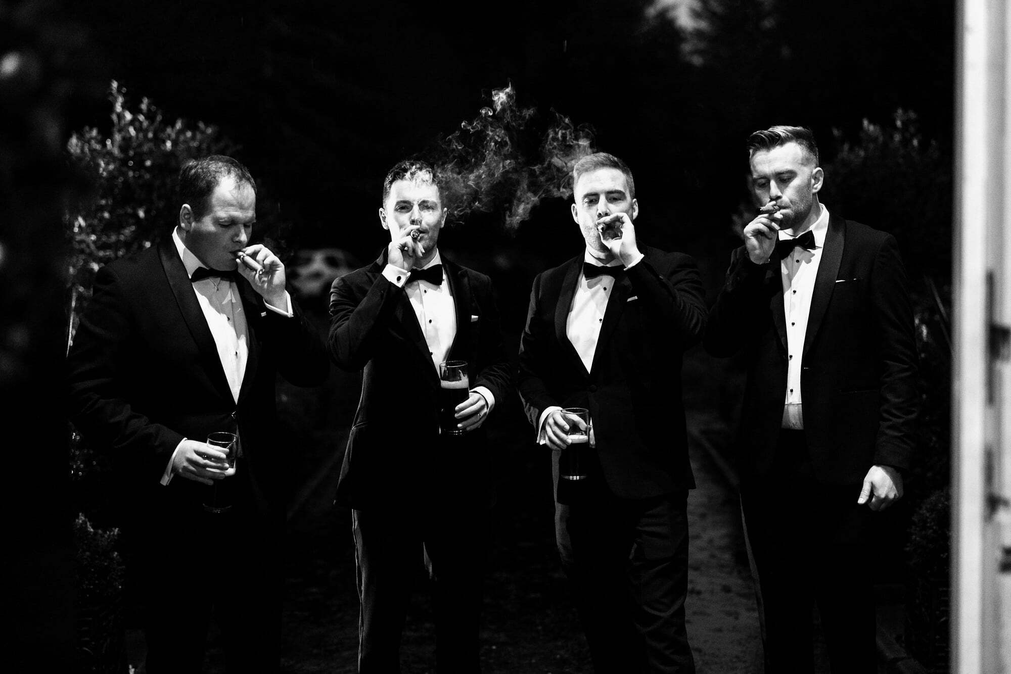 groom groomsmen cigar smoking winter micro wedding at drumtochty castle scottish highlands aberdeenshire