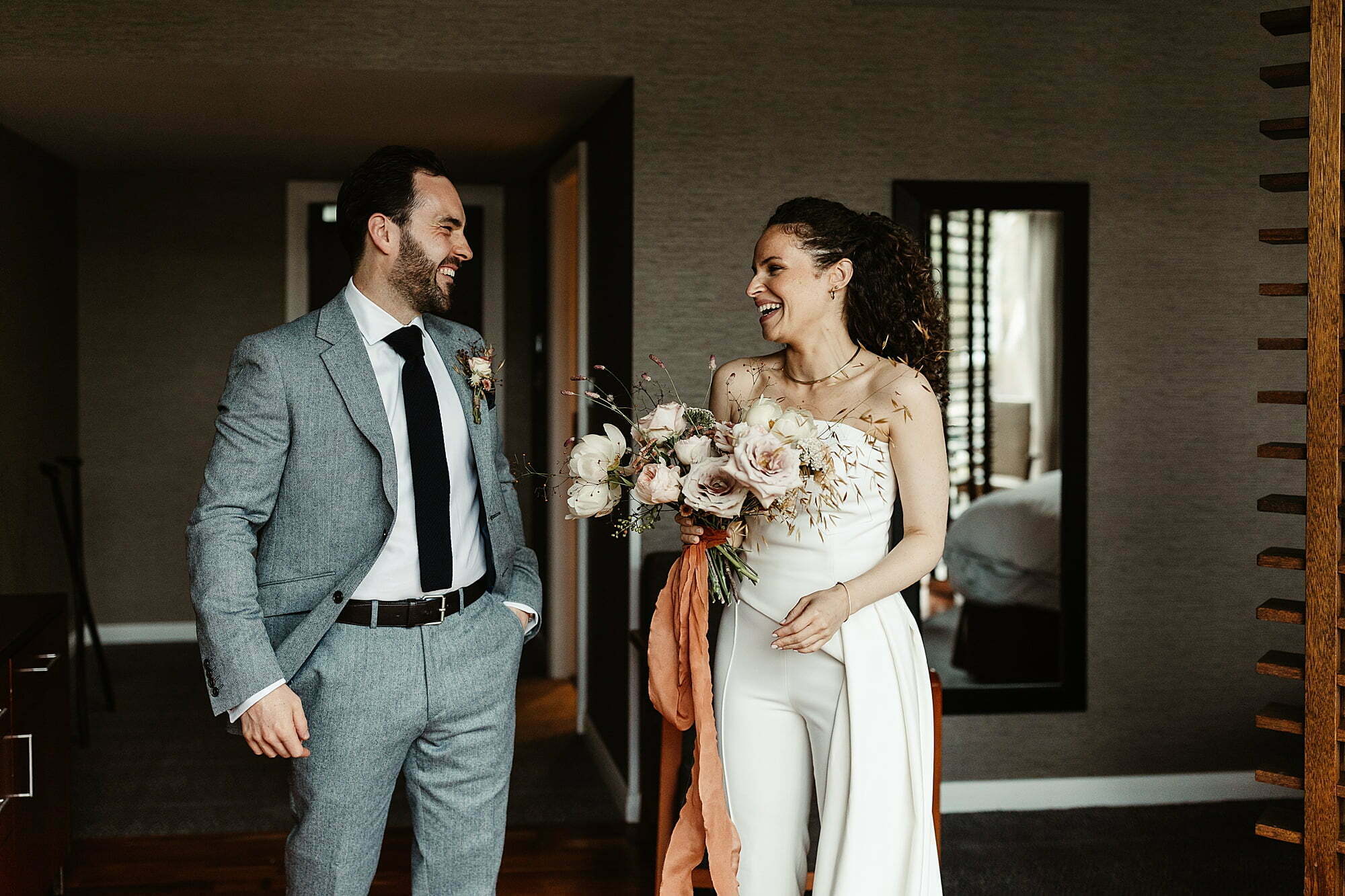 bride and groom edinburgh elopement city chambers white trouser suit wild flowers bouquet