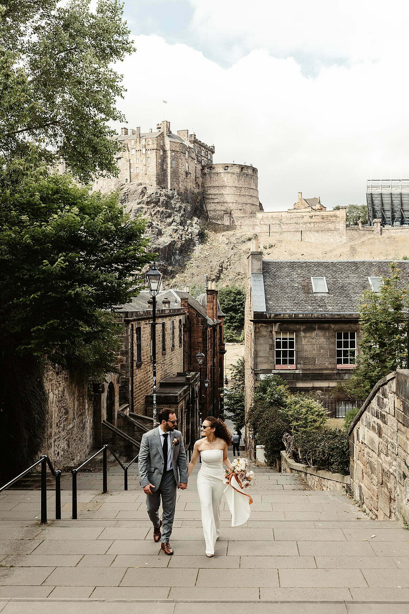 bride and groom Nadine Merabi trouser suit white edinburgh castle elopement