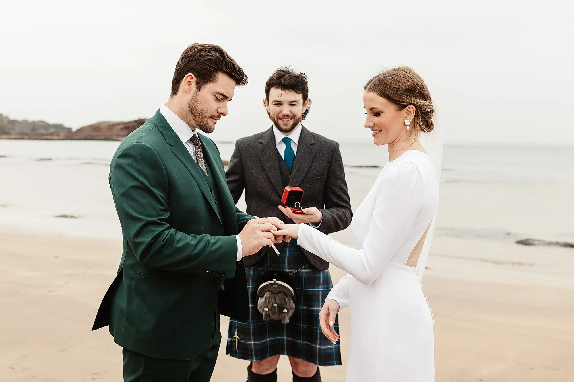 seacliff beach micro wedding ceremony bride and groom Park and Fifth Co dress ring exchange