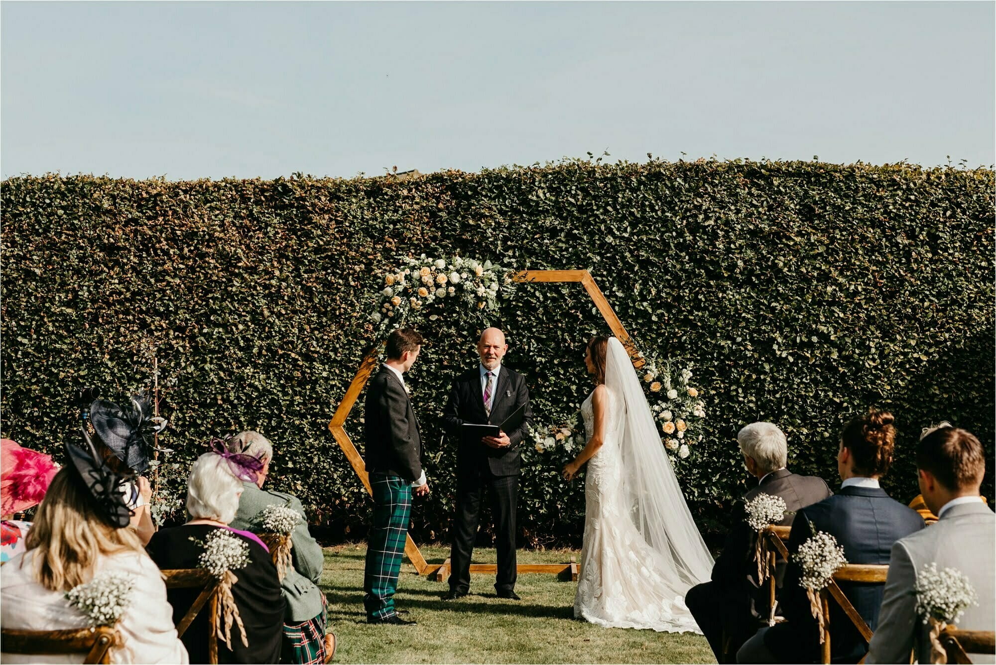 farm micro wedding scottish borders bride groom marriage ceremony with luxury event styling scotland hexagonal wooden backdrop