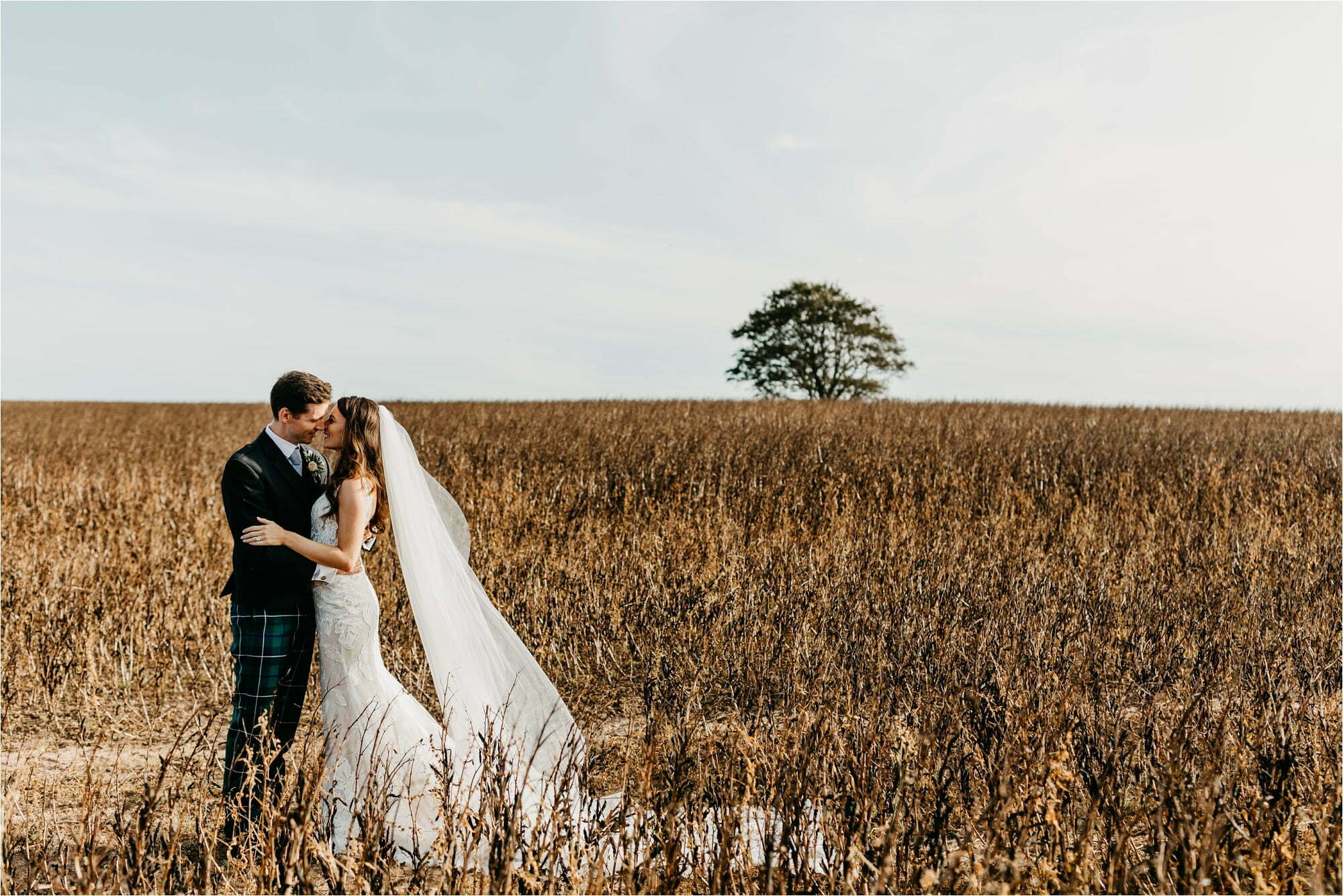 farm micro wedding scottish borders bride groom in field walking laughing portraits