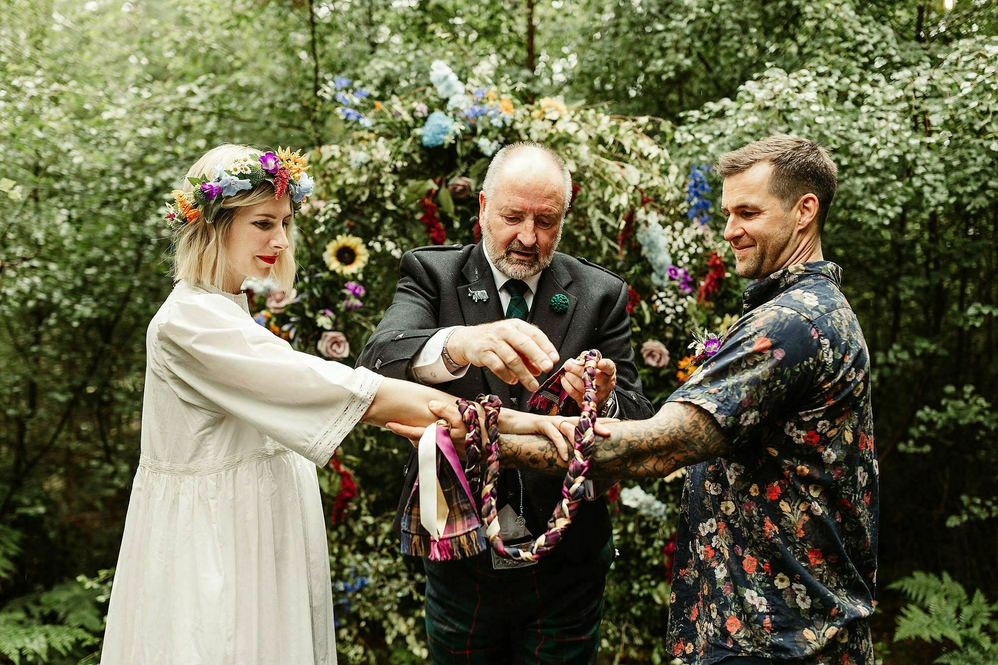 bride groom tying the knot colourful ribbons