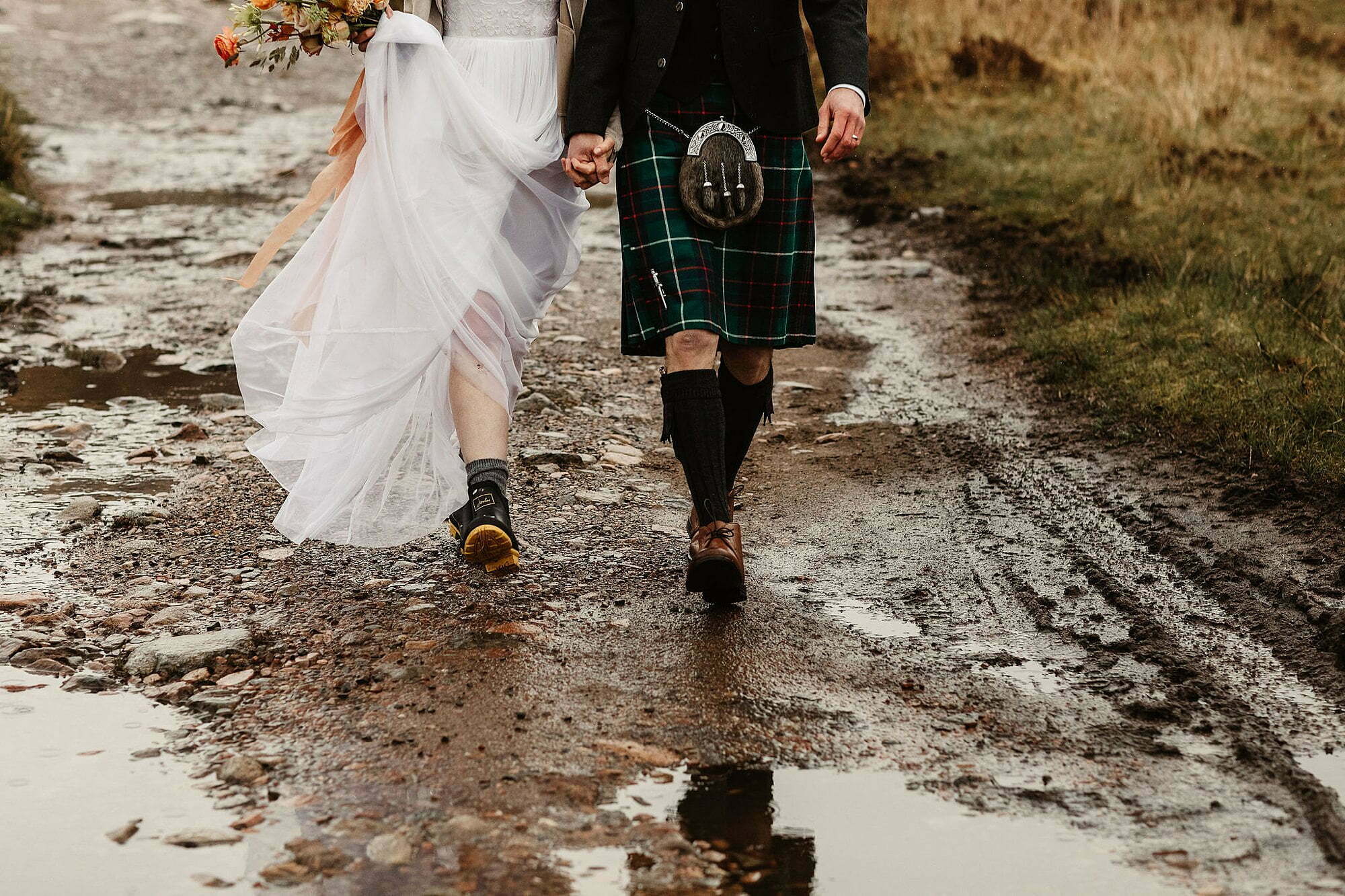 glencoe elopement photography bride groom walking boots tartan kilt 