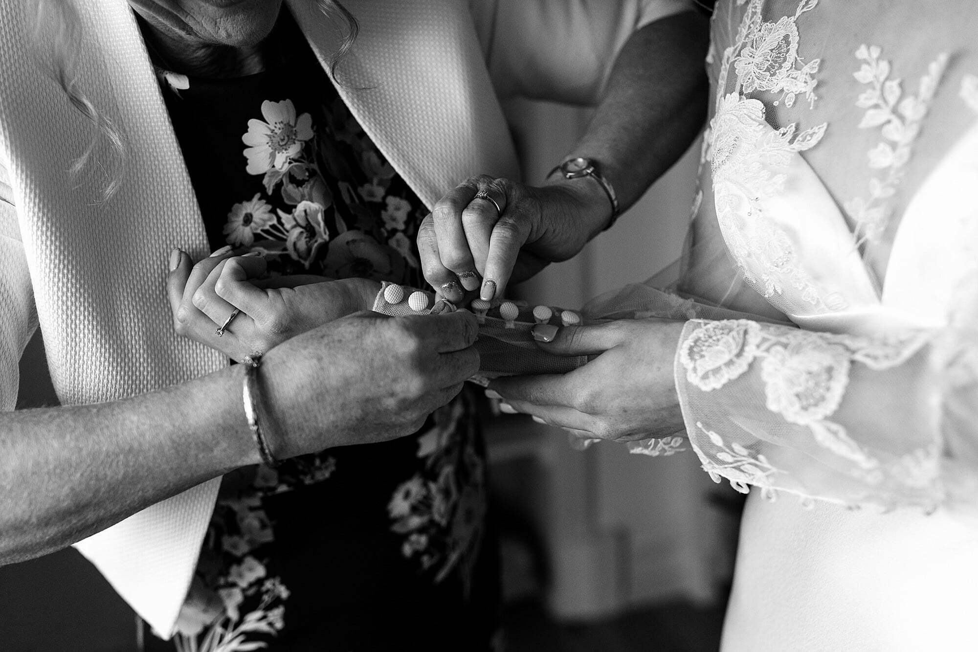 guardswell farm winter wedding mother helping bride get dressed david fielden dress