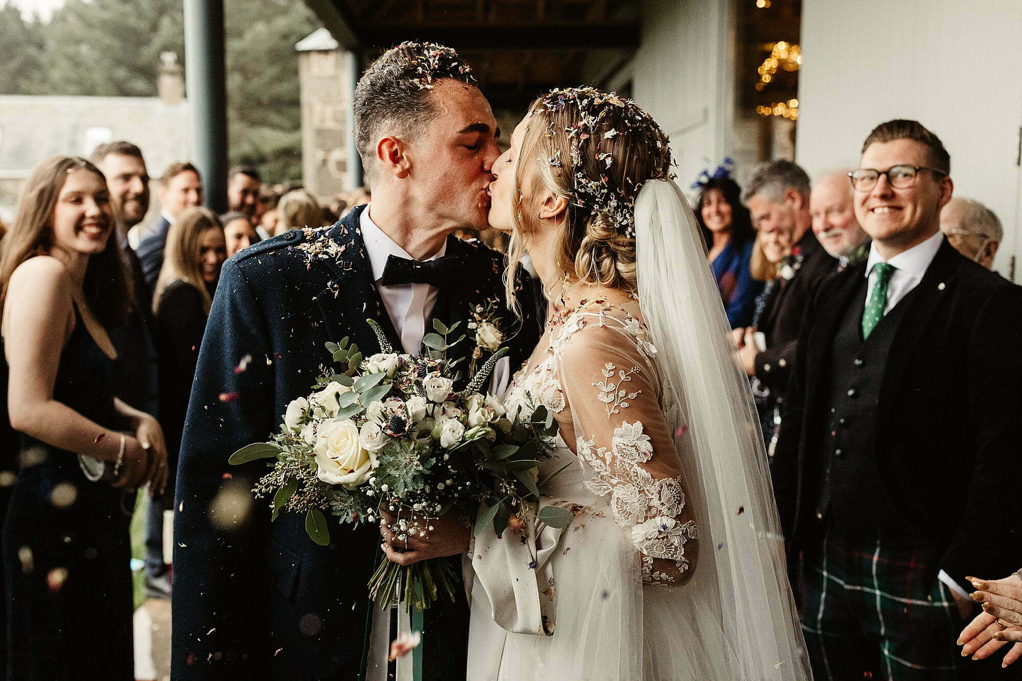 guardswell farm winter wedding confetti bride and groom kiss