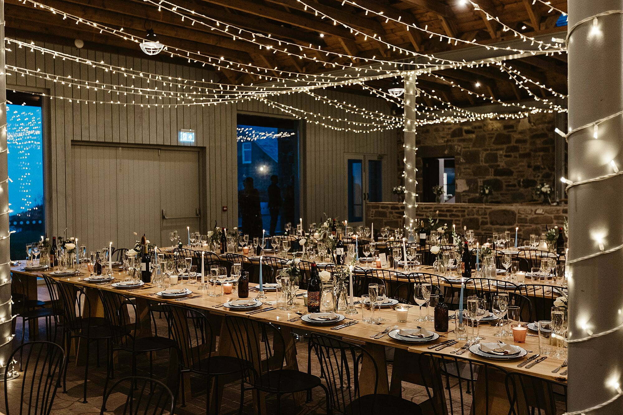guardswell farm winter wedding dinner room table setting rustic fairy lights