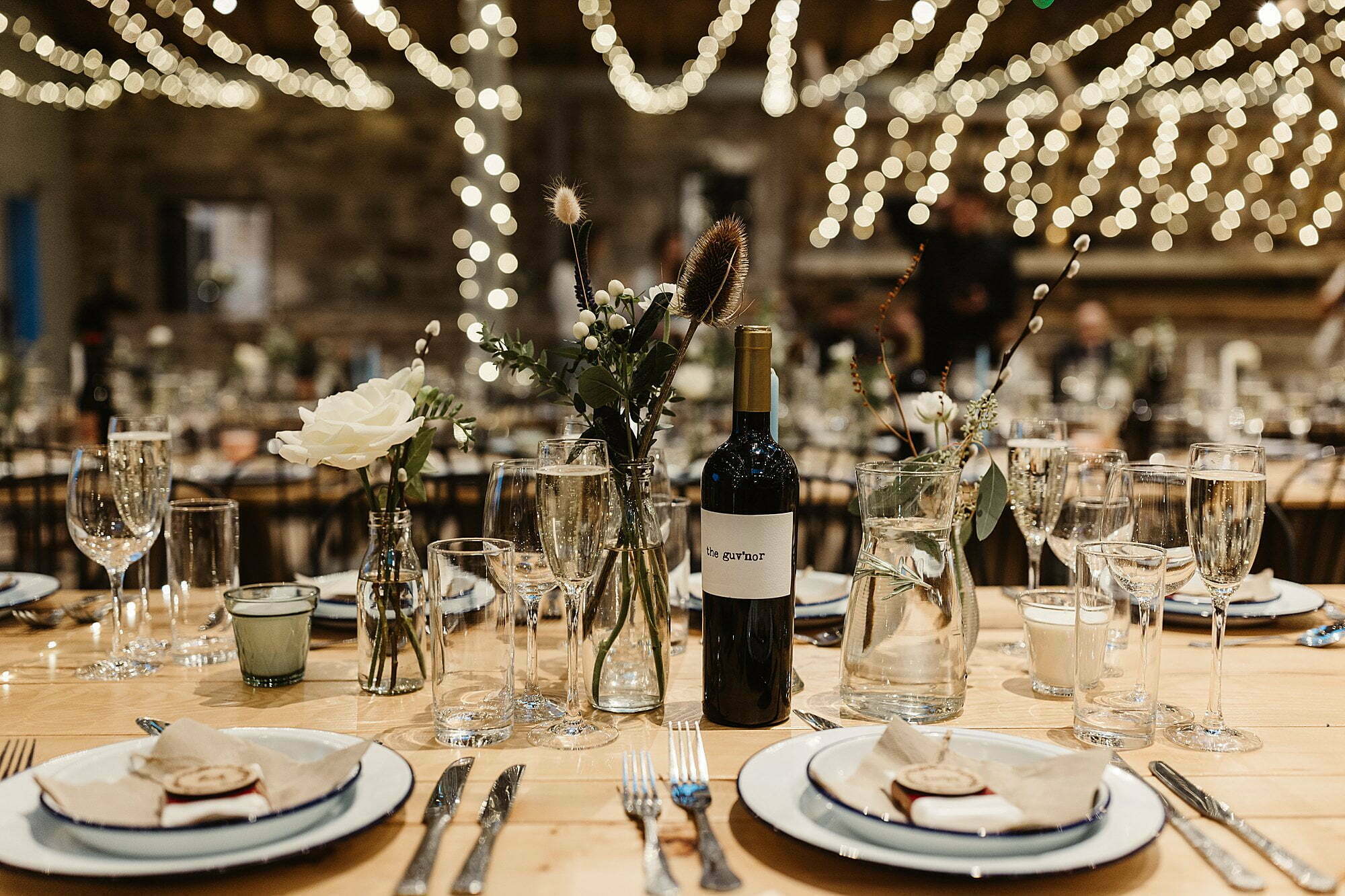 guardswell farm winter wedding dinner room table setting rustic fairy lights