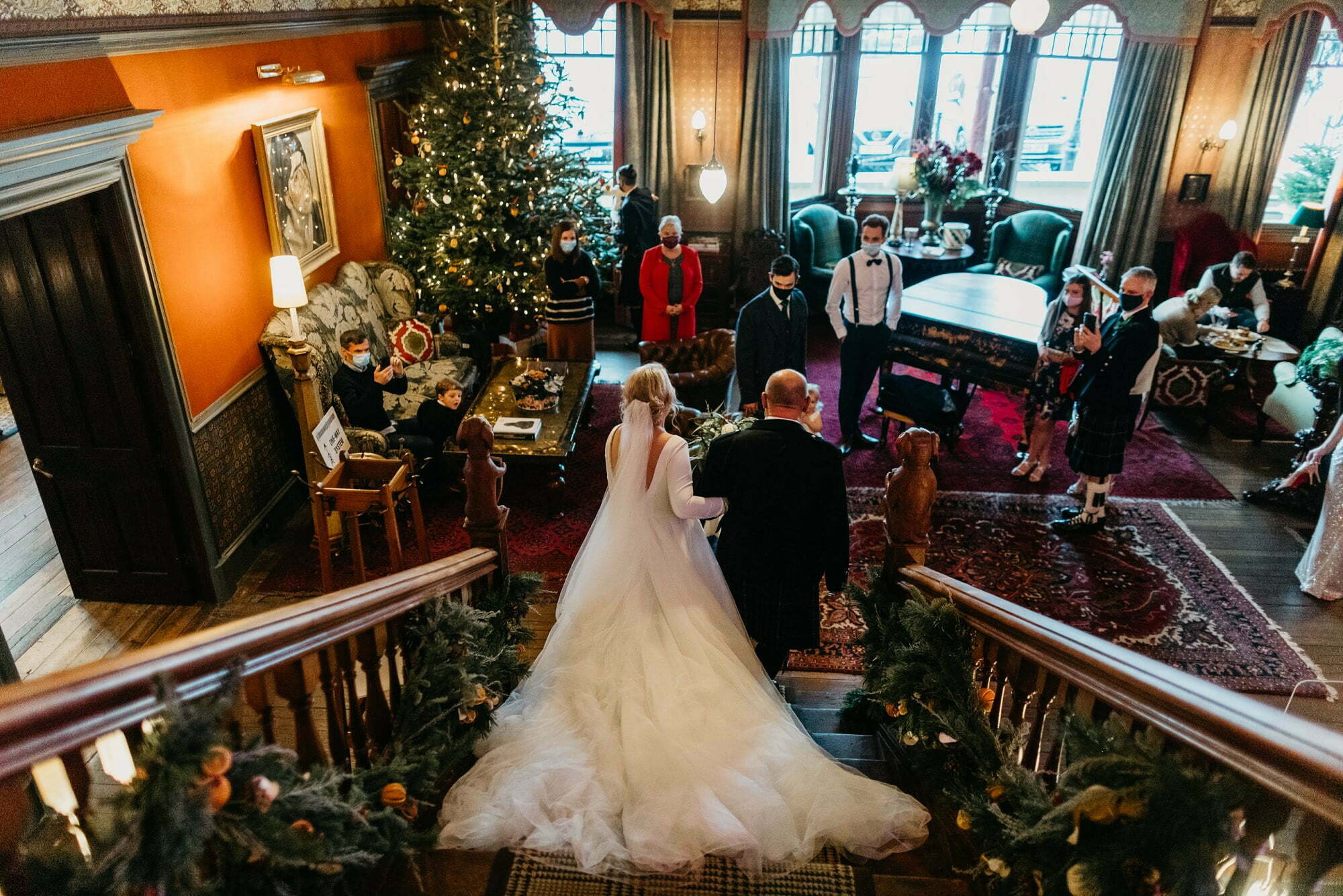 fife arms hotel braemar wedding bride walking down staircase with dad on way to wedding