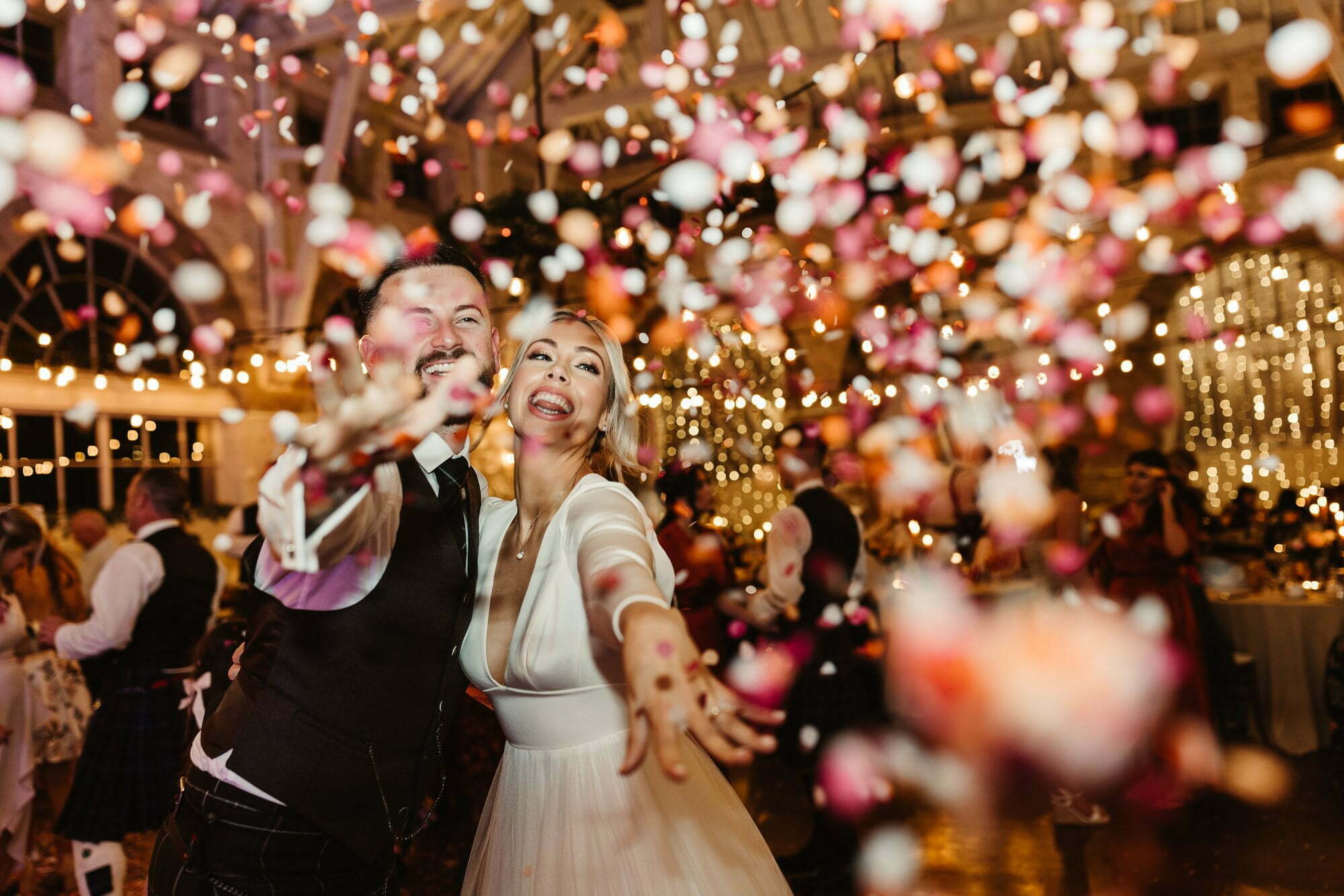 bride groom throw confetti on wedding reception dancefloor at coos cathedral wedding aberdeenshire