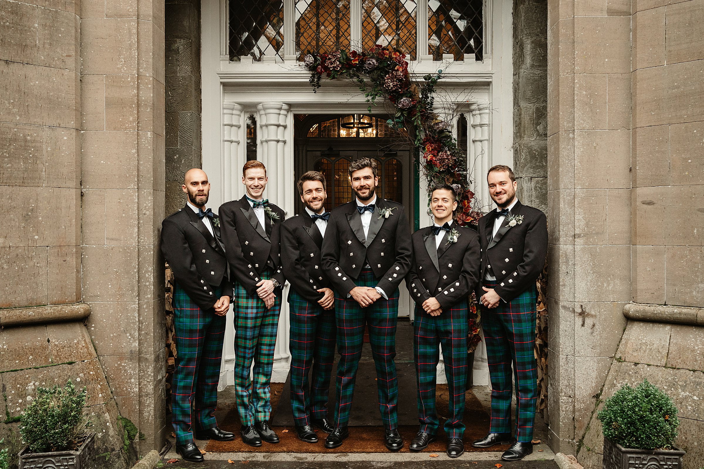 Drumtochty castle winter wedding groom portraits group photo groomsmen Gunn & Grant tartan trews