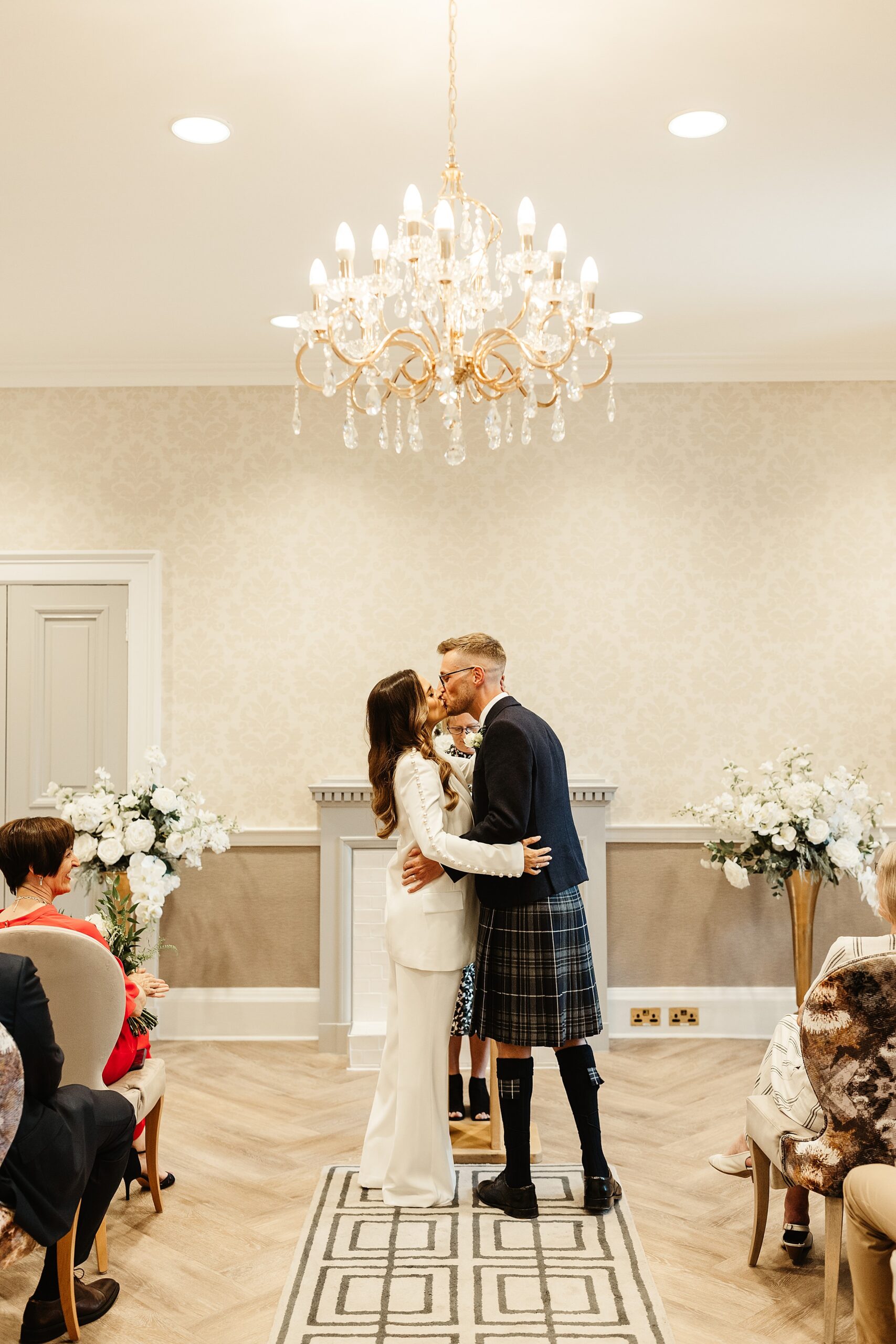 bride and groom ceremony room edinburgh city chambers elopement first kiss Nadine Merabi trouser suit