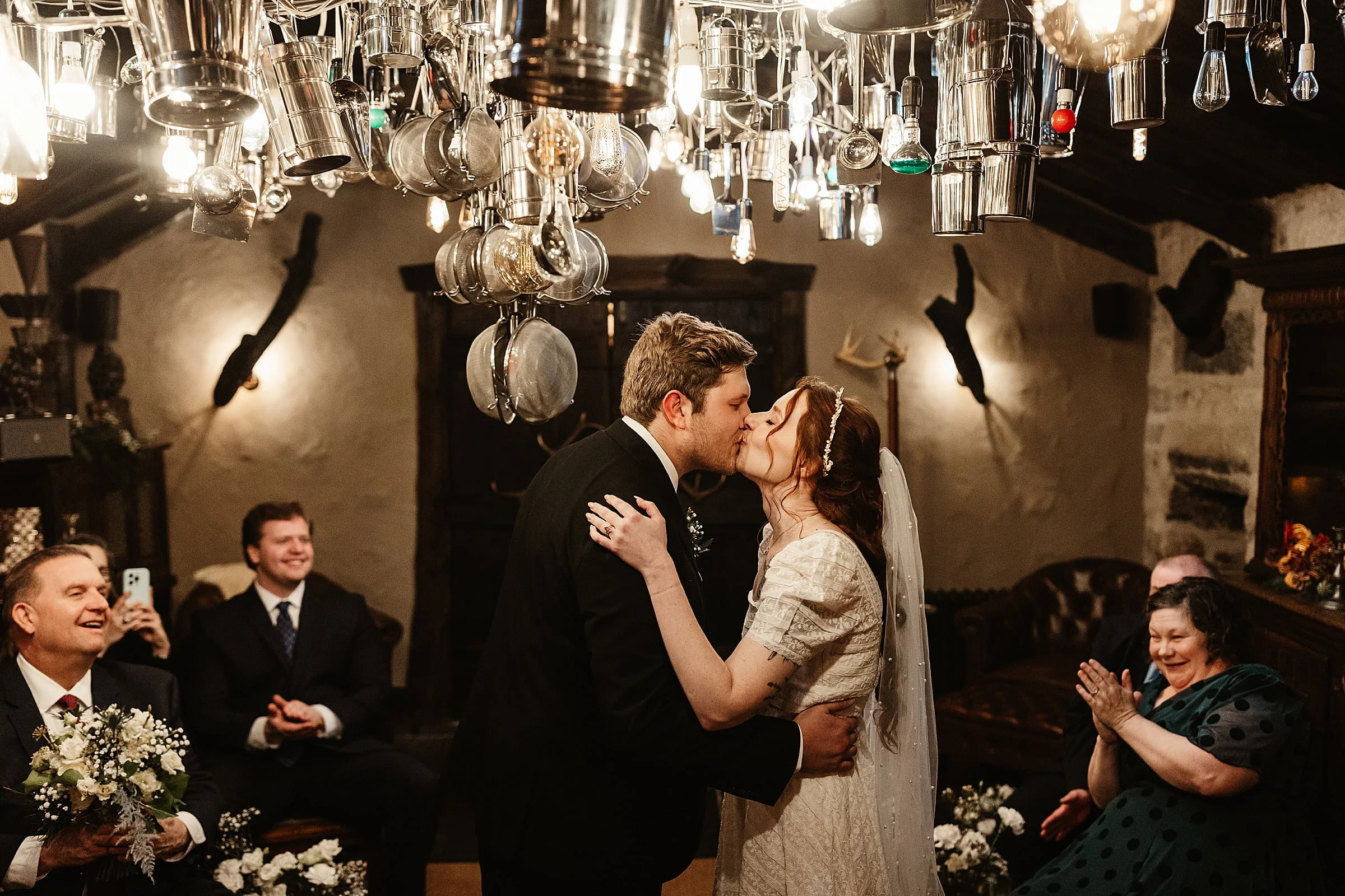 fife arms wedding ceremony indoors bride and groom first kiss
