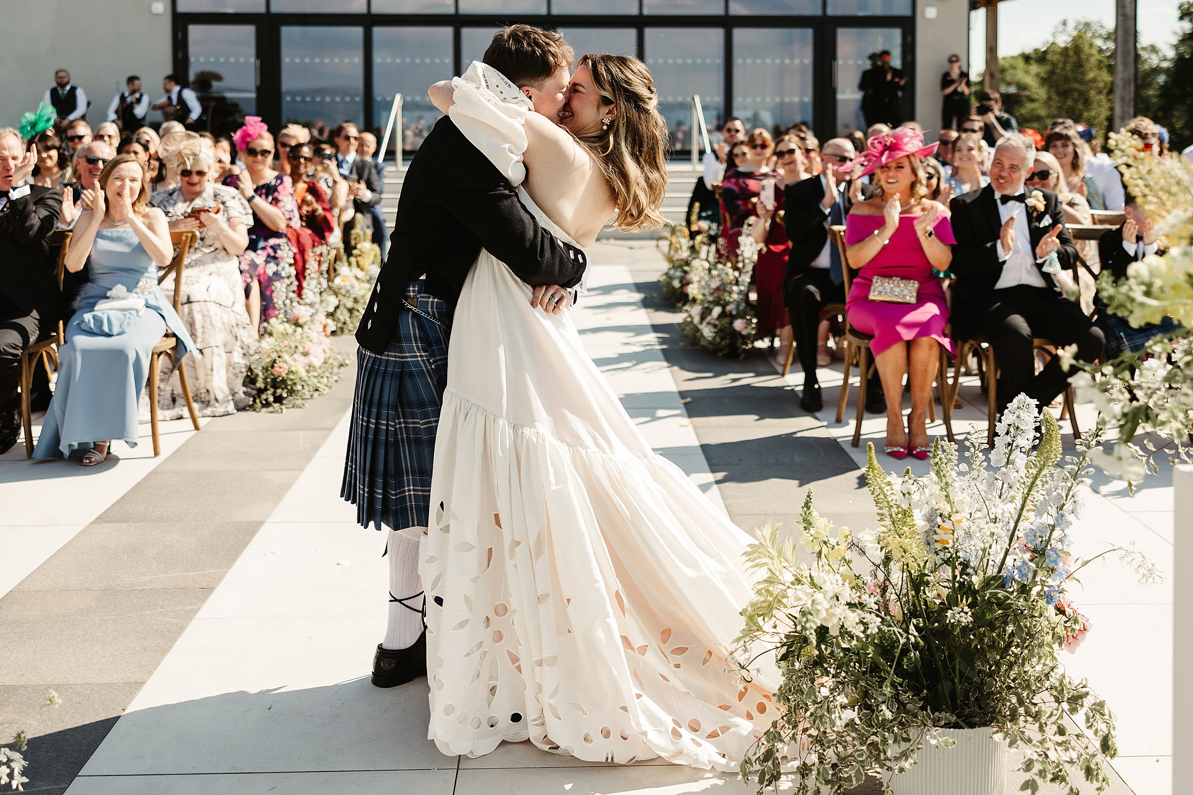 boturich castle wedding ceremony outdoors on the shore of loch lomond bride and groom first kiss