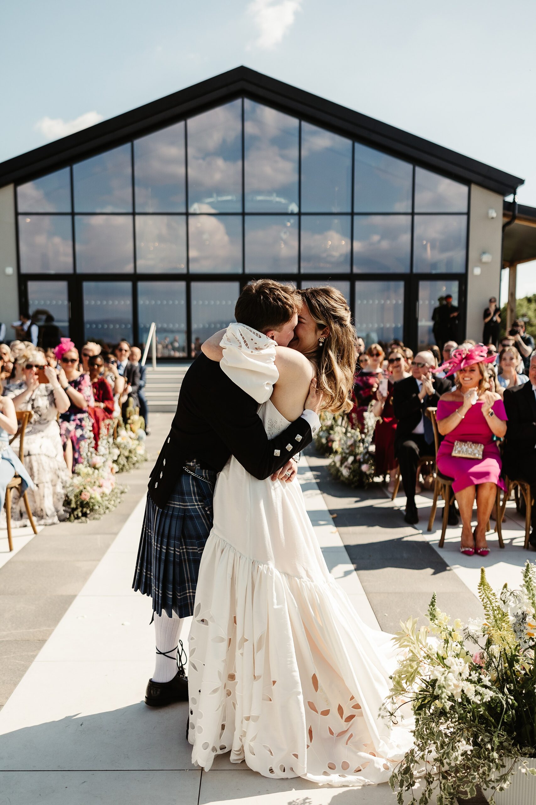 boturich castle wedding ceremony outdoors on the shore of loch lomond bride and groom first kiss