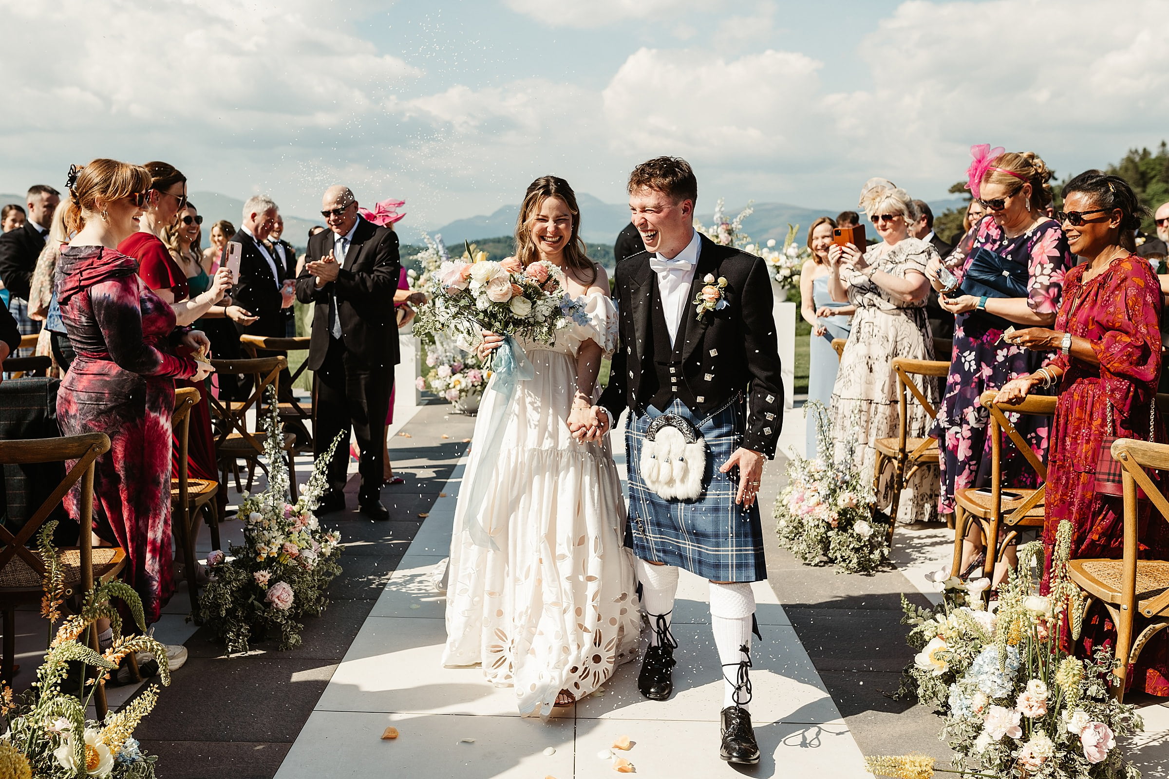 boturich castle wedding ceremony outdoors bride and groom confetti throw