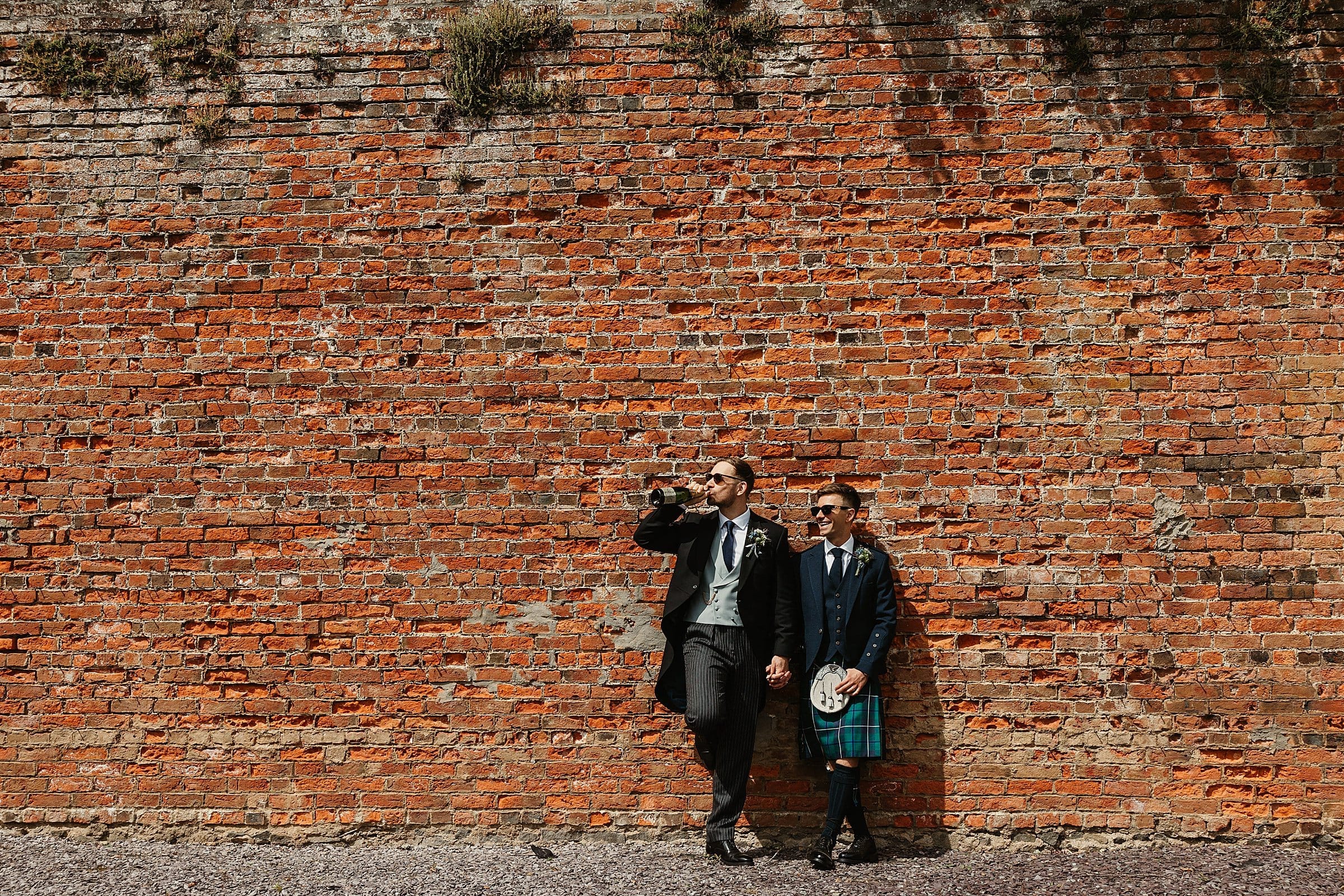 byre at inchyra same sex wedding portraits two grooms wedding photography sunglasses drinking champagne from the bottle