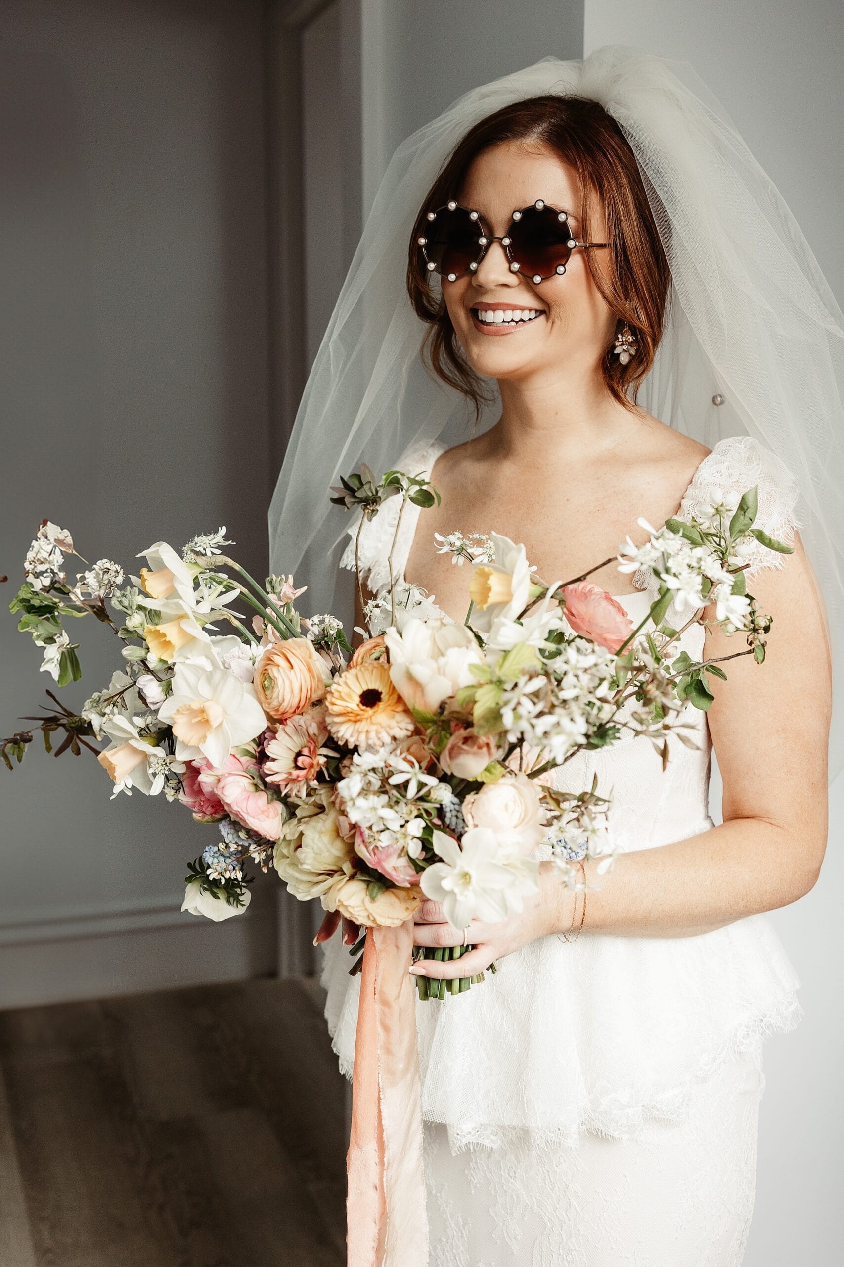 virgin hotels edinburgh elopement bride with sunglasses and celandine flower bouquet