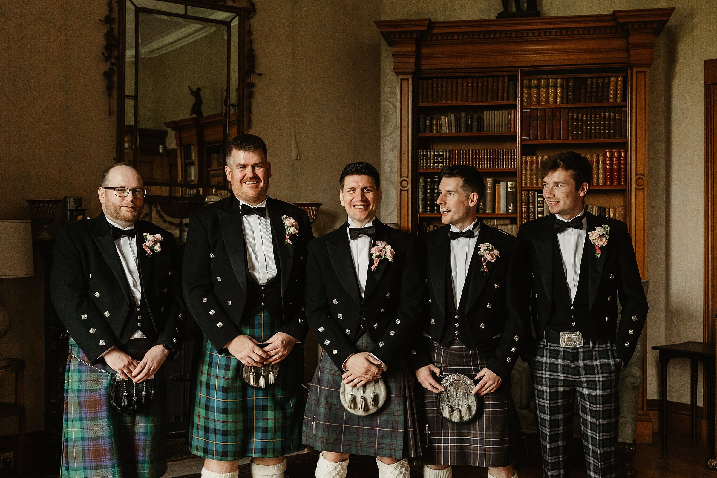 cluny castle wedding groomsmen group photo indoors kilts
