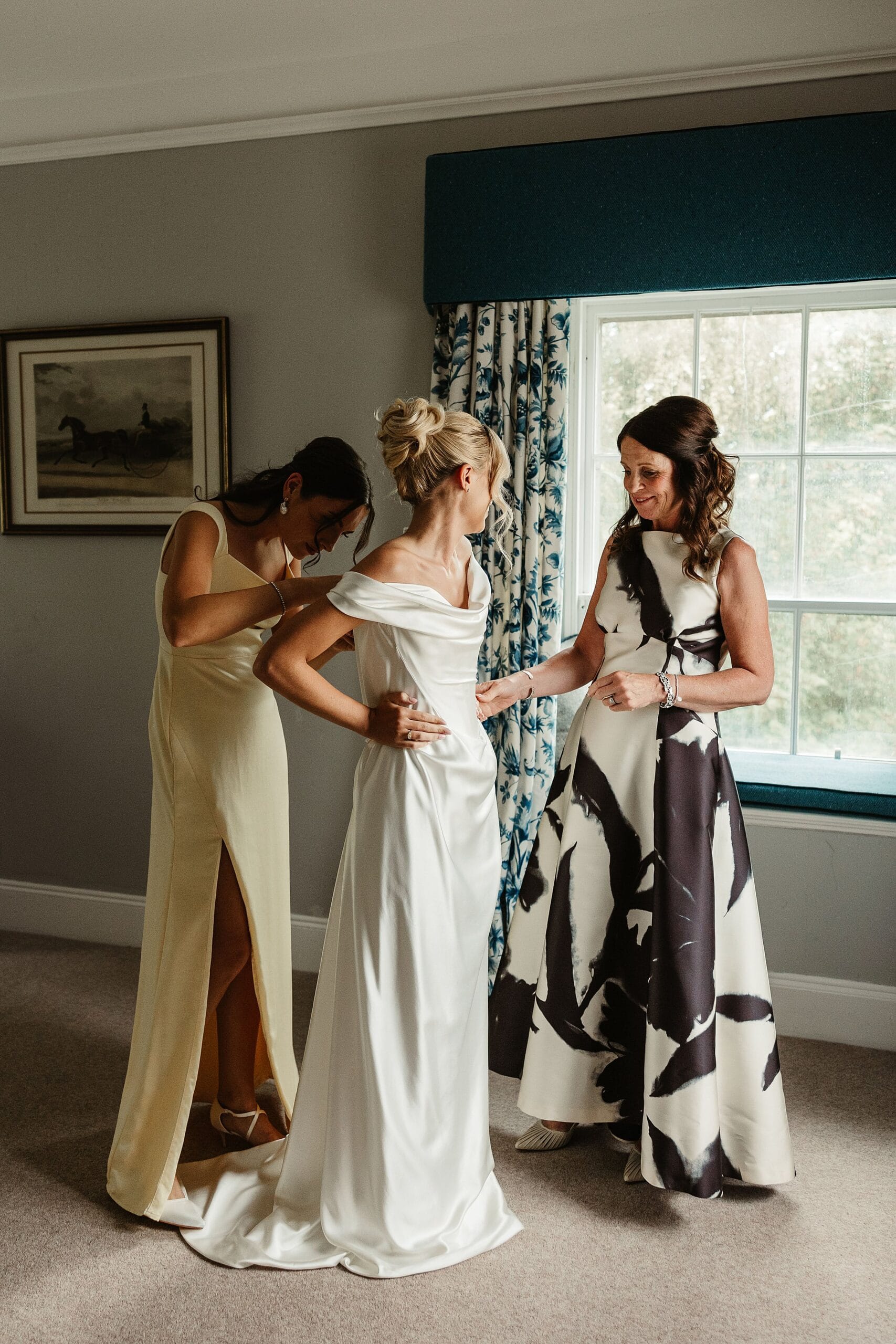 cluny castle wedding bride getting ready with mum and bridemaid vivienne westwood dress
