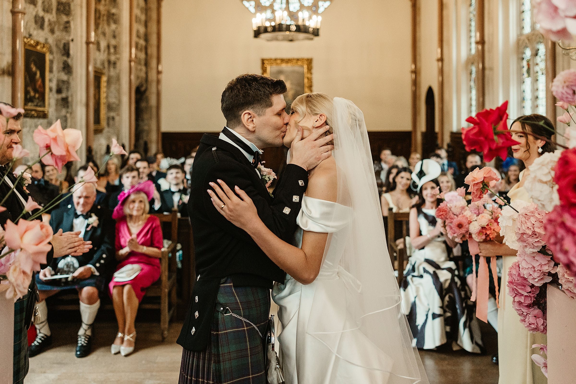 cluny castle wedding ceremony in chapel bride and groom first kiss