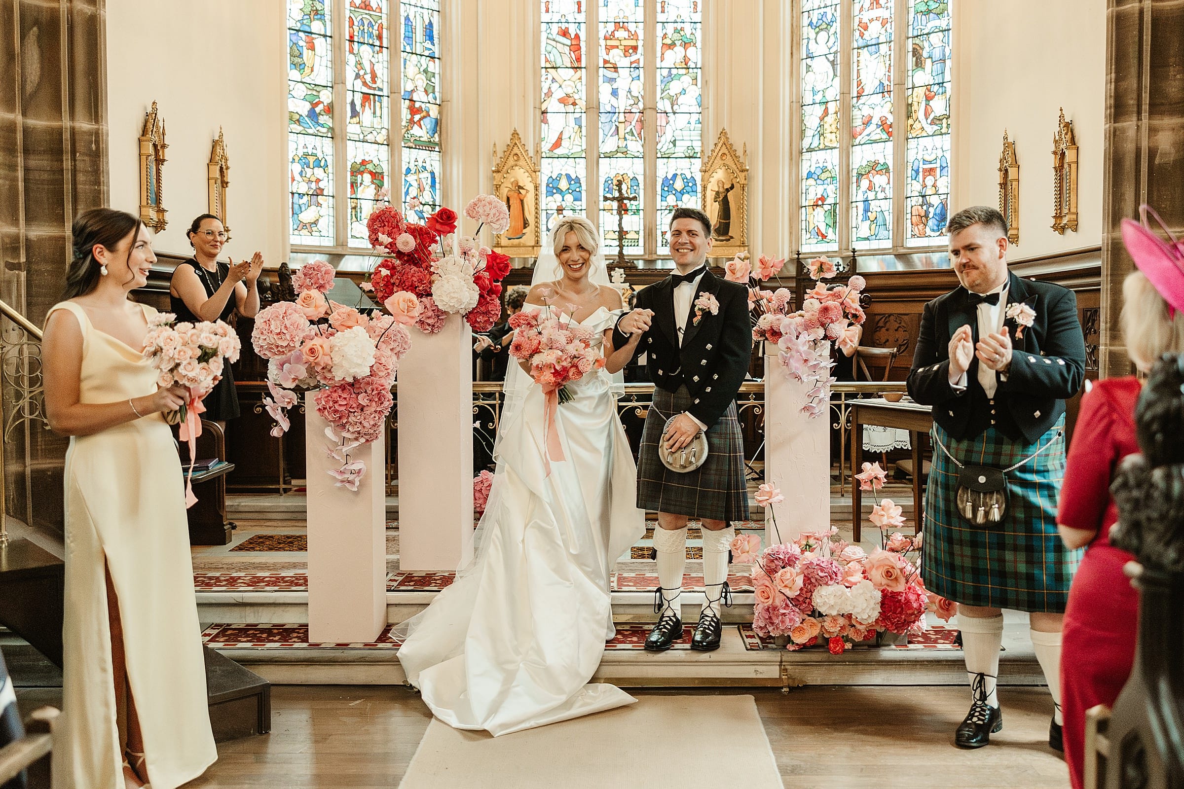 cluny castle wedding ceremony in chapel pink florals and vivienne westwood dress