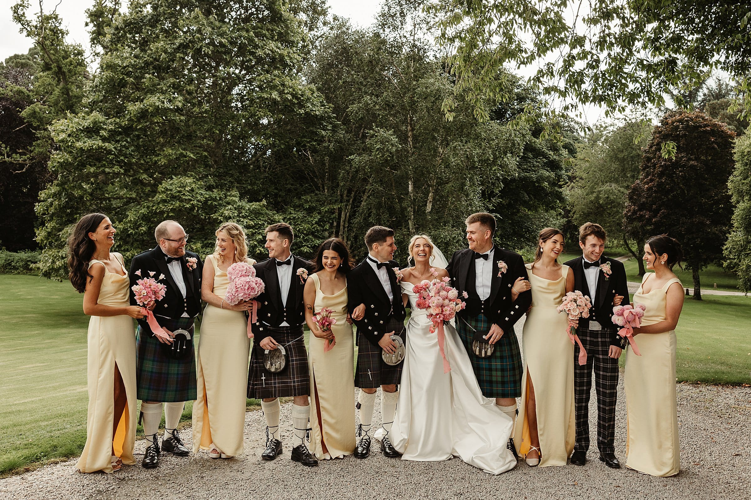 cluny castle wedding photography group photos bridesmaids yellow dresses groomsmen kilts